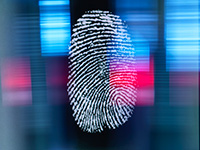 Thumbprint on a blurred background of blue and pink representing biometric security offered by ATM service NJ 