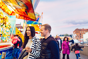 Those who buy homes for sale in Metuchen NJ can enjoy community events like this couple at a fair